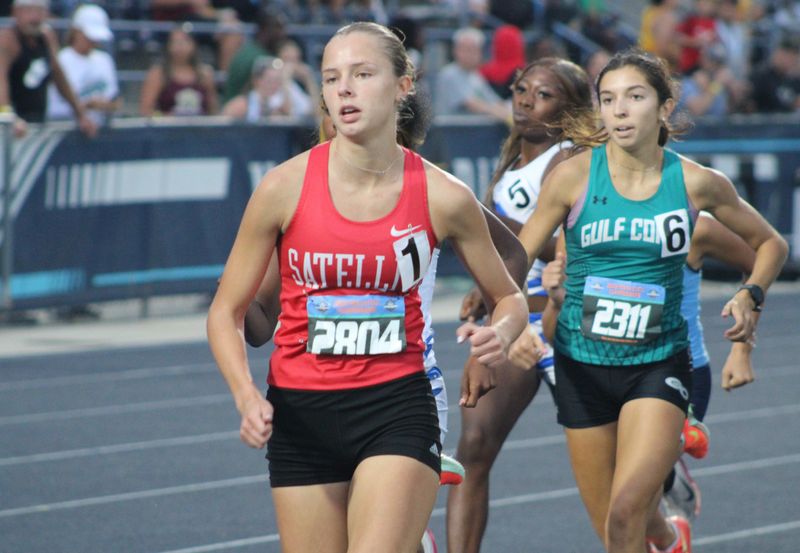 Satellite's Keira Merrick (2804) and Naples Gulf Coast's Kiara Rakes (2311) lead the pack in the girls 800 during the FHSAA Class 3A high school track and field championships in Jacksonville, Florida, on May 8, 2026. [Clayton Freeman/Florida Times-Union]