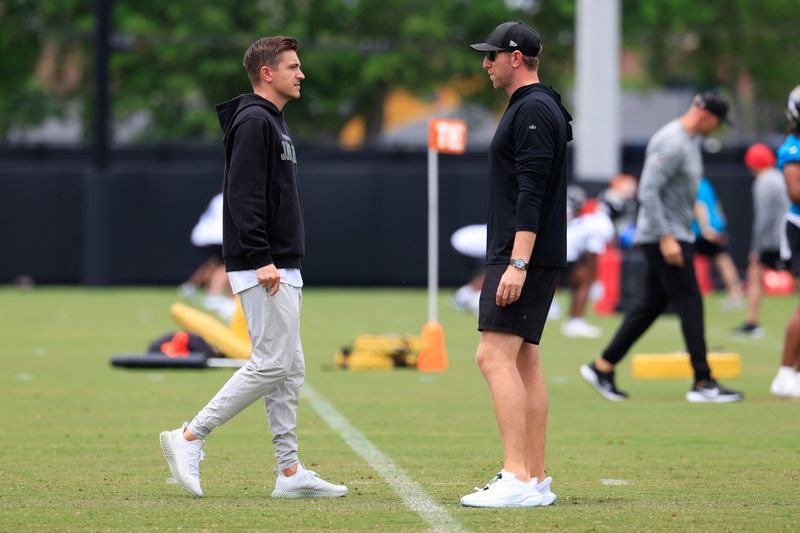 Jacksonville Jaguars general manager James Gladstone, left, and head coach Liam Coen talk during rookie minicamp at the Miller Electric Center, Saturday, May 9, 2026 in Jacksonville, Fla. Today was the second of a three day camp concluding Sunday.