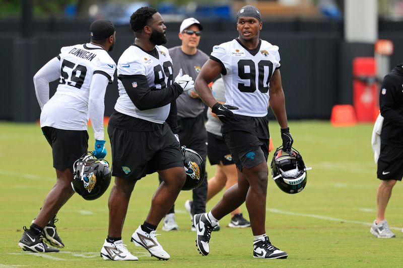 Jacksonville Jaguars defensive tackle Albert Regis (98) and defensive end Wesley Williams (90) run off the field during rookie minicamp at the Miller Electric Center, Saturday, May 9, 2026 in Jacksonville, Fla. Today was the second of a three day camp concluding Sunday.