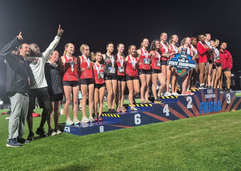 Creekside athletes and coaches celebrate on the podium after winning the FHSAA Class 4A girls track and field team championship on May 9, 2026. [Clayton Freeman/Florida Times-Union]
