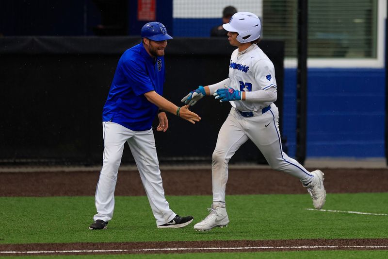 Trinity Christian's Jordan Martinez high-fives coach Jon Murphy after a May 9 home run against Bishop Snyder. Martinez is tied for second in Florida with 12 home runs.
