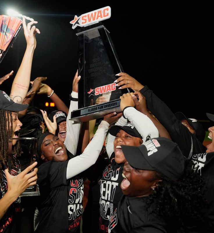 Florida A&M Rattlers players hoist the NCAA Southwestern Athletic Conference Softball Tournament championship trophy after beating the Southern Jaguars at the Gulfport Sportsplex in Gulfport, Mississippi, Saturday, May 9, 2026.