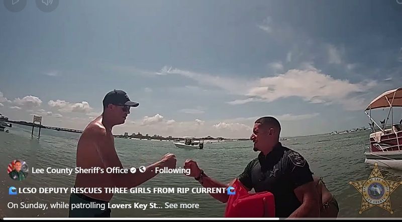 Deputy Raymond Tellez Ferriol, with the Lee County Sheriff's Office, rushed into a rip current in the Gulf and guided three girls to shore amid anchored pleasure crafts and a pontoon on Sunday, May 10, 2026. Here he gives a celebratory fist bump to one of the onlookers.