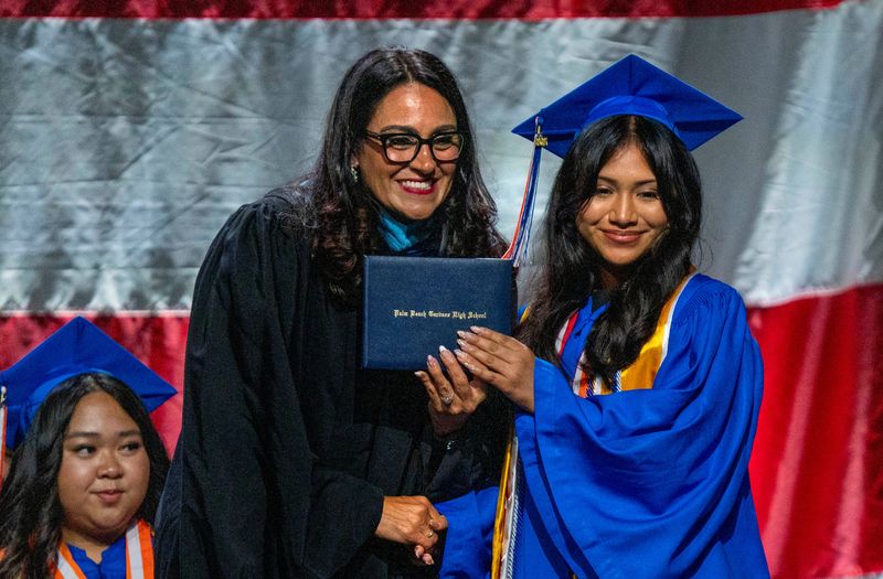 Principal Michelle Fleming hands out diplomas at the Palm Beach Gardens graduation ceremony at the South Florida Fairgrounds on May 11, 2026, in suburban West Palm Beach, Florida.