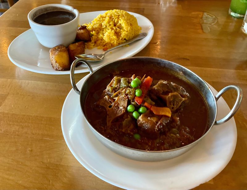 The Rabo de Res at Don Ramon Restaurante Cubano features oxtail slowly cooked to perfection with spices and a touch of red wine reduction. It is fall-off-the-bone tender! It is served with rice, beans and plantains.