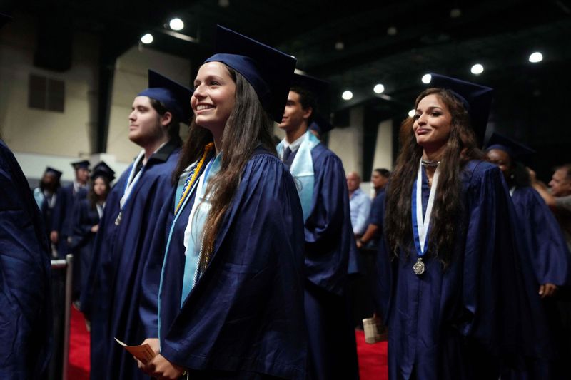 Students and faculty gather during the West Boca Raton High School graduation ceremony at the South Florida Fairgrounds on May 12, 2026, in suburban West Palm Beach, Florida.