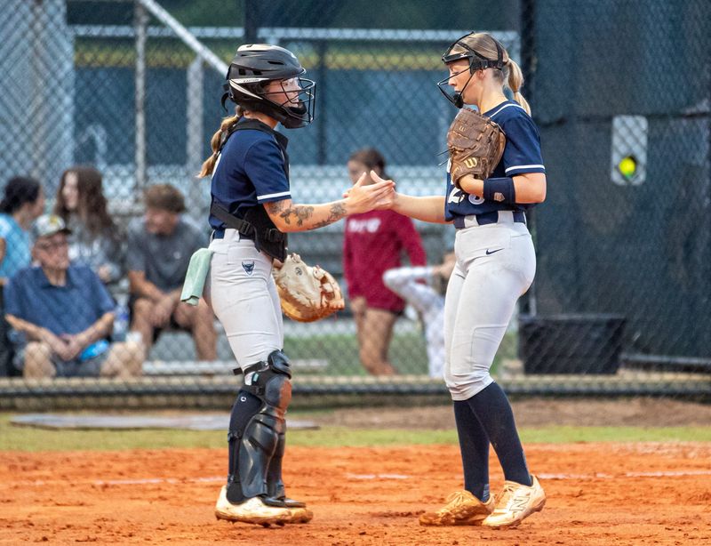 Parrish Community defeated Mitchell 3-1 on Tuesday, May 12 in a Region 6A-3 softball semifinal. Catcher Cassidy Ott, left, and pitcher Emmaline Van Beck meet before the fourth inning.