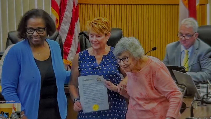 Mayor Berry presents a proclamation designating May as National Historic Preservation Month in Leesburg to former mayor and preservation board Sanna Henderson, and at center, preservation board member Vickie Lingerfelt at the May 11, 2026 Leesburg City Commission meeting.