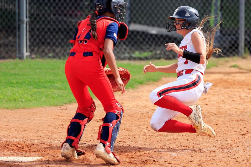 Baker County's Sadye Harvey (1) scores the game-winning run against Fort Walton's Elyse Heymann (11) after being batted in during the eighth inning of an FHSAA Class 1-4A regional softball semifinal, Wednesday, May 13, 2026, in Glen Saint Mary, Fla. Baker County edged Fort Walton Beach 6-5 in eight innings. [Corey Perrine/Florida Times-Union]