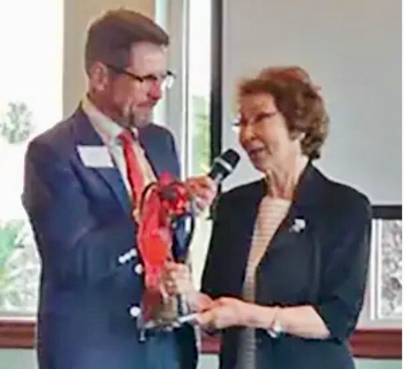 A Heart of Volusia, Inc.'s website photo shows board member Glenn Vincent presenting a heart-shaped sculpture to Sally Baumeier-Stevens, who recently retired from Heart of Volusia’s Board of Directors, after 43 years’ service.