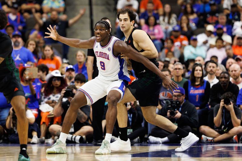 Nov 16, 2025; Gainesville, Florida, USA; Florida Gators center Rueben Chinyelu (9) calls for the ball while Miami Hurricanes center Salih Altuntas (11) defends during the second half at VyStar Veterans Memorial Arena. Mandatory Credit: Matt Pendleton-Imagn Images