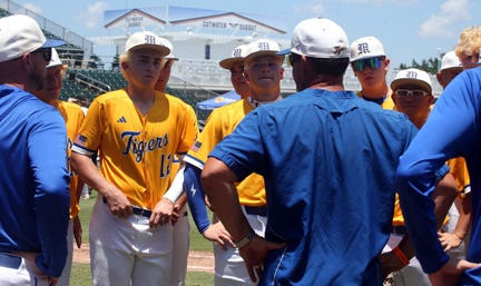 Martin County players listen to Coach Brett Hawkins after losing to Buchholz in the Class 6A State Semifinal on Friday at Lee Health Sports Complex - Hammond Stadium in Fort Myers. Buchholz defeated the Tigers, 3-2.