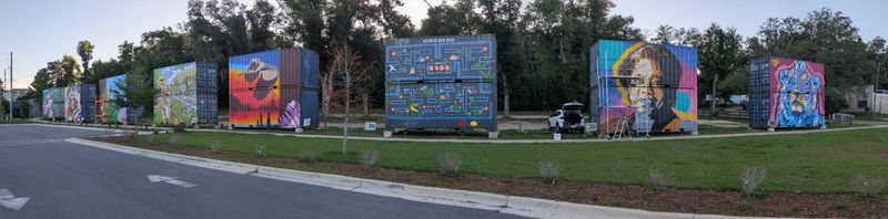 The painted container cars outside SoMo Walls are the largest public mural installation in Tallahassee.