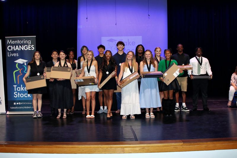Class of 2026 Take Stock in Children of St. Johns County graduating class with their graduation gift, new laptop computers.