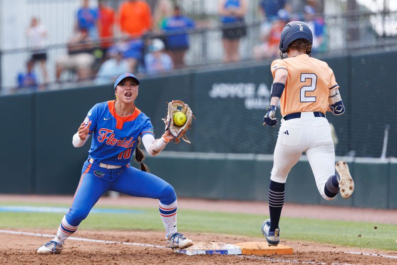 May 16, 2026; Gainesville, FL, USA; Florida Gators infielder Gabi Comia (10) makes the catch at first base before Georgia Tech Yellow Jackets outfielder Raegan Wall (2) touches during the fifth inning at Katie Seashole Pressly Stadium. Mandatory Credit: Matt Pendleton-Imagn Images