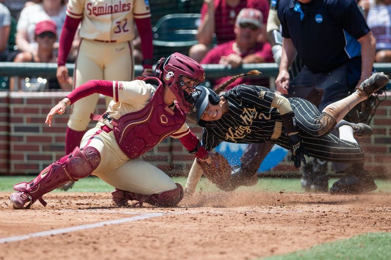 Florida State Seminoles catcher Madi Frey (24) tries to tag UCF Knights infielder Samantha Rey (2) dives into home plate. The Florida State Seminoles defeated the UCF Knights 2-1 on Sunday, May 17, 2026. The teams must play one more game to determine the NCAA Tallahassee regional winner.