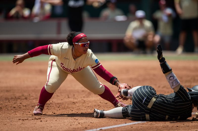 Florida State Seminoles infielder Jaysoni Beachum (42) tries to tag the runner as they dive into third base. The Florida State Seminoles defeated the UCF Knights 2-1 on Sunday, May 17, 2026. The teams must play one more game to determine the NCAA Tallahassee regional winner.