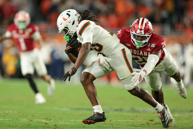 Jan 19, 2026; Miami Gardens, FL, USA; Indiana Hoosiers linebacker Rolijah Hardy (21) tackles Miami Hurricanes wide receiver Malachi Toney (10) in the fourth quarter during the College Football Playoff National Championship game at Hard Rock Stadium. Mandatory Credit: Sam Navarro-Imagn Images