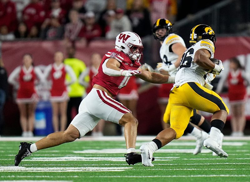 Wisconsin Badgers linebacker Christian Alliegro (0) tackles Iowa Hawkeyes running back Xavier Williams (26) during the first half of the game on Saturday October 11, 2025 at Camp Randall in Madison, Wisconsin.