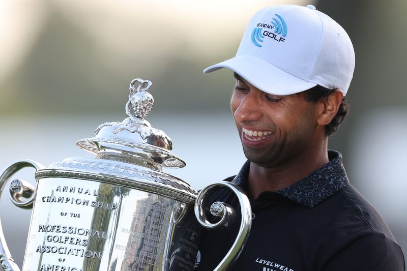 Aaron Rai poses with the trophy after winning the final round of the PGA Championship golf tournament.