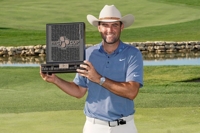 Scottie Scheffler poses with the winner's trophy during the final round of the The CJ Cup Byron Nelson golf tournament in McKinney, Texas.