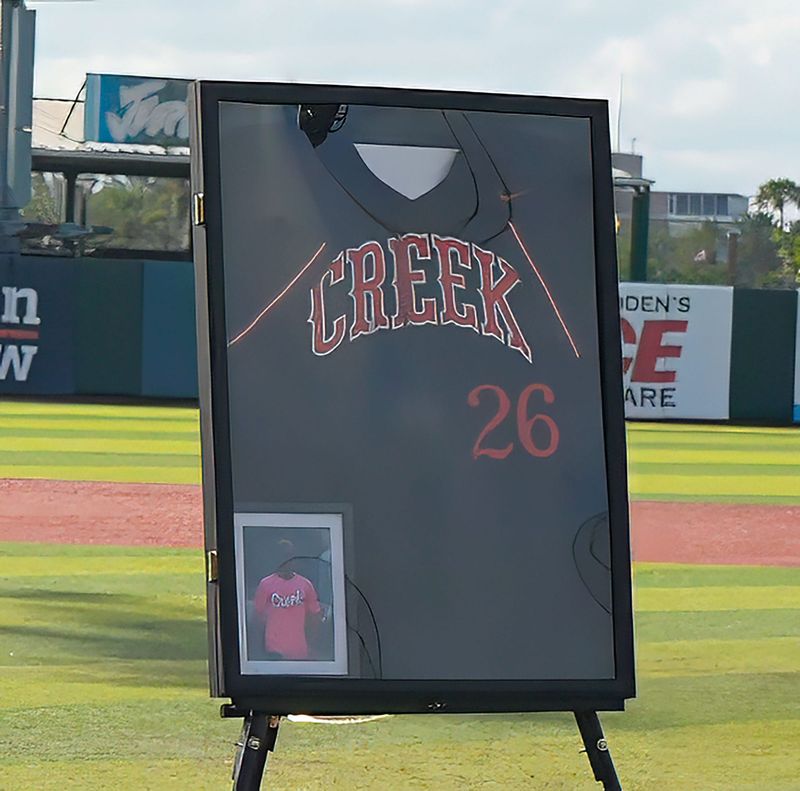 Spruce Creek assistant baseball coach Adam Smith jersey was displayed at the front of his memorial service held at Jackie Robinson Ballpark on Monday, May 18, 2026.