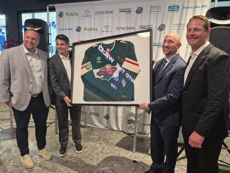 Jacksonville Icemen coach Sean Teakle, Zawyer Sports vice president of hockey operations Joe Ernst, Icemen chief executive officer Andy Kaufmann and Iowa Wild general manager Matt Hendricks line up following the Icemen's affiliation agreement with the NHL's Minnesota Wild on May 18, 2026. [Clayton Freeman/Florida Times-Union]