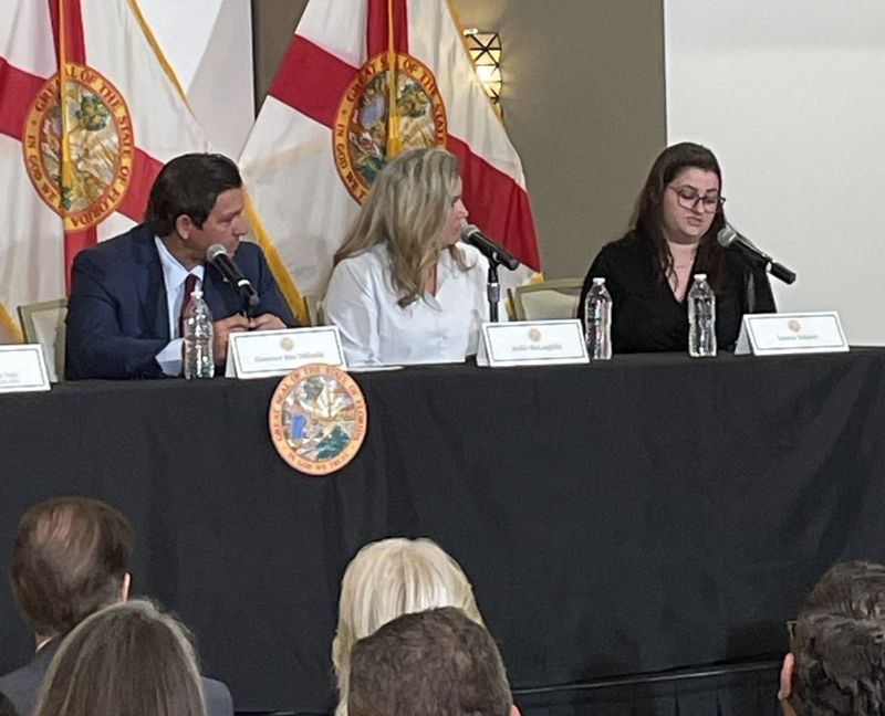 Gov. Ron DeSantis listens to Leanne Yehnert (far right) talk about how she's struggling with the cost of living in her new home in Brevard. She and her mother, Jackie McLaughlin, participated in a discussion Monday about eliminating homestead property taxes. The event was held at the Space Coast Association of Realtors in Melbourne.