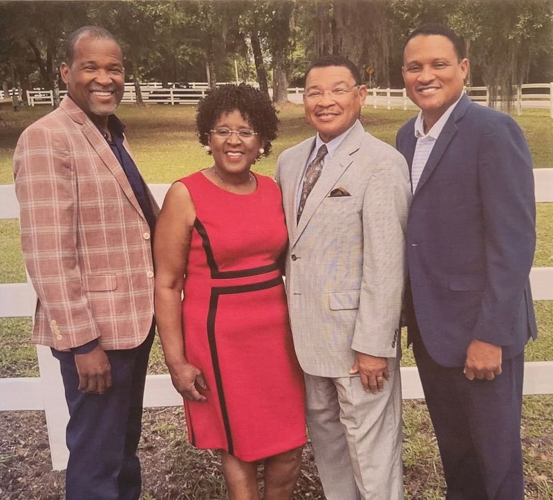 Dr. Pink Hightower (second to left) poses with his wife Pam Hightower (second to right) and their two sons Michael Hightower (far left) and Terence Hightower (far right).