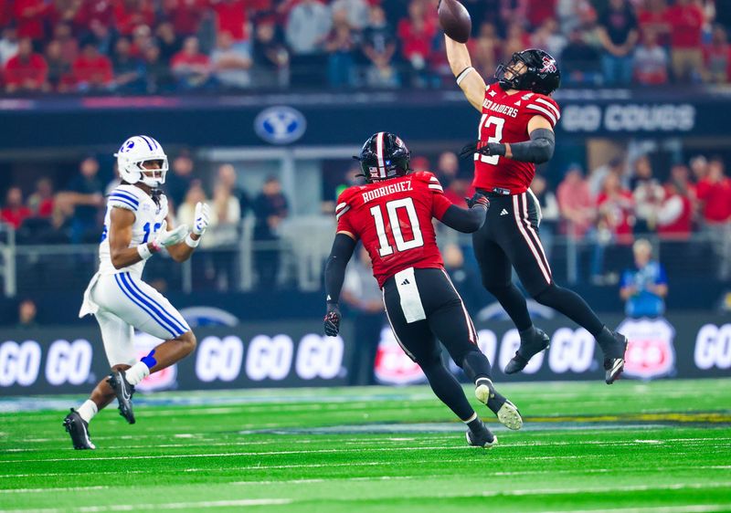Dec 6, 2025; Arlington, TX, USA; Texas Tech Red Raiders linebacker Ben Roberts (13) makes an interception intended for BYU Cougars wide receiver Jojo Phillips (13) during the second half at AT&T Stadium. Mandatory Credit: Kevin Jairaj-Imagn Images