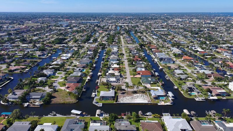 Canals are visible throughout most areas in Cape Coral. Cape Coral features over 400 miles of navigable man-made canals - the world's largest canal system, often called the "Venice of America" - originally created to dredge and elevate land for development. Image captured May 7, 2026.