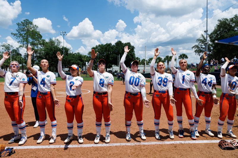 May 17, 2026; Gainesville, FL, USA; Florida Gators pitcher Keagan Rothrock (7), Florida Gators infielder Kalie Matsuno (4), Florida Gators catcher Giulia Desiderio (2), Florida Gators catcher Jocelyn Erickson (8), Florida Gators pitcher Ava Brown (00), Florida Gators pitcher Katelynn Oxley (39), Florida Gators pitcher Caroline Stanton (1), Florida Gators outfielder Townsen Thomas (44) and Florida Gators infielder Gabi Comia (10) perform a Gator Chomp after the game against the Georgia Tech Yellow Jackets at Katie Seashole Pressly Stadium. Mandatory Credit: Matt Pendleton-Imagn Images