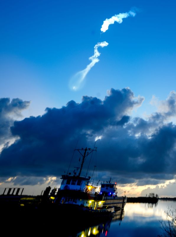 Tugboats are illuminated by the launch of a SpaceX Falcon 9 rocket from Cape Canaveral Space Force Station on May 21.