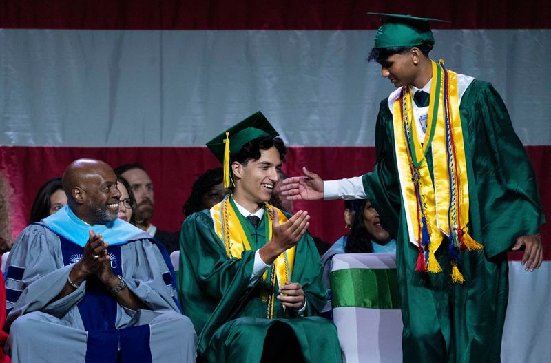 Suncoast High salutatorian Sreethan Enjem, right, reaches out to valedictorian Vladimir Kolev during the at the Suncoast High School graduation ceremony at the South Florida Fairgrounds. The school's performance has landed it in the U.S. News & World Report's Top 100 ranking of the nation's public high schools.