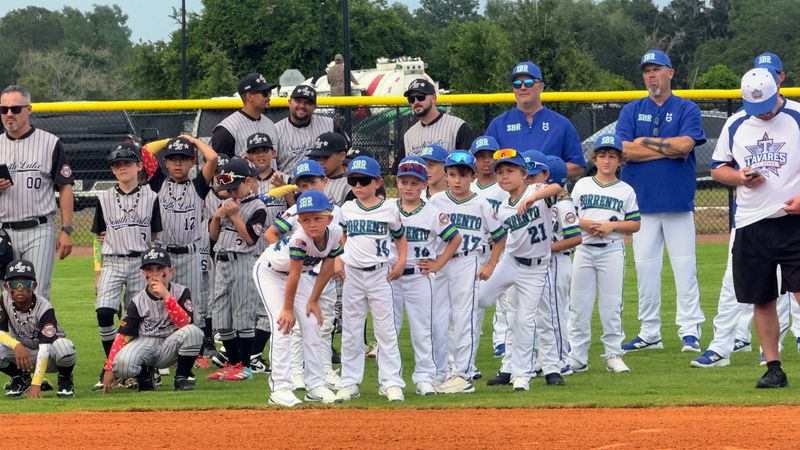 Cal Ripken All-Stars players from Lake County wait to take the field as city officials deliver welcoming remarks during the grand opening of South Lake Regional Park on May 21.