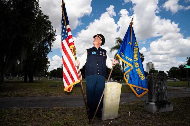 Forrest Myers, Commander of the Col. Robert W. Barnard Camp #2 Department of Florida, Sons of Union Veterans of the Civil War stands for a portrait at the gravesite of Christian Funk at the Fort Myers Cemetery on Friday, May 22, 2026. The SUVCW is honoring Funck on Memorial Day on Monday, May 25, 2026. Funck was a Drummer Boy in the Union Army in the Civil War. He made his way to Fort Myers and had an impact on the community before his death.