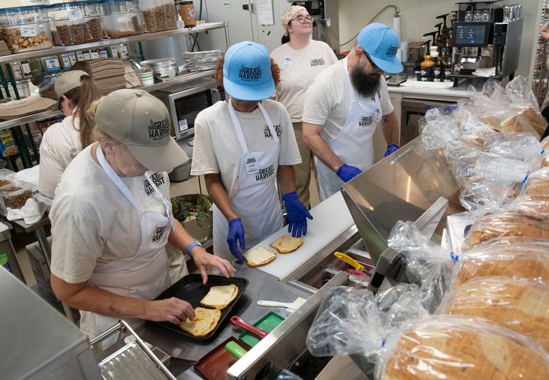 Great Harvest employees prepare fresh-from-the-oven pastries, breads, and sandwiches for customers on May 23, 2026. Great Harvest, located in the Savoy Market, is a downtown bakery offering handmade bread, pastries, sweets, and sandwiches, all made fresh every day.