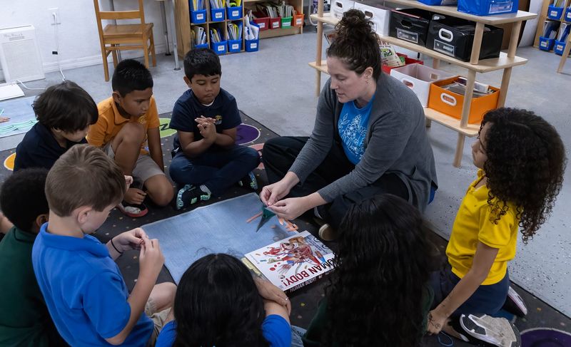 Teacher Kim Rauck leads a group of students in a lesson about muscles in a LOWER ELEMENTARY classroom at Mi Escuela Montessori in Lakeland. The school is moving to a new building in Bartow for the next school year.