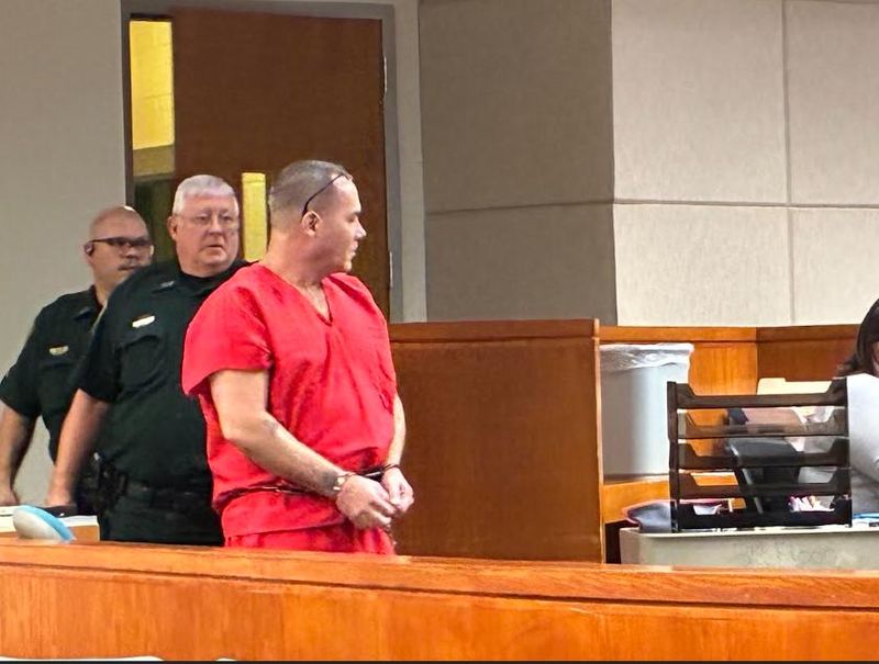 Eric Thanal Lutterloah being escorted to the defense table for his change of plea hearing on May 27, 2026.