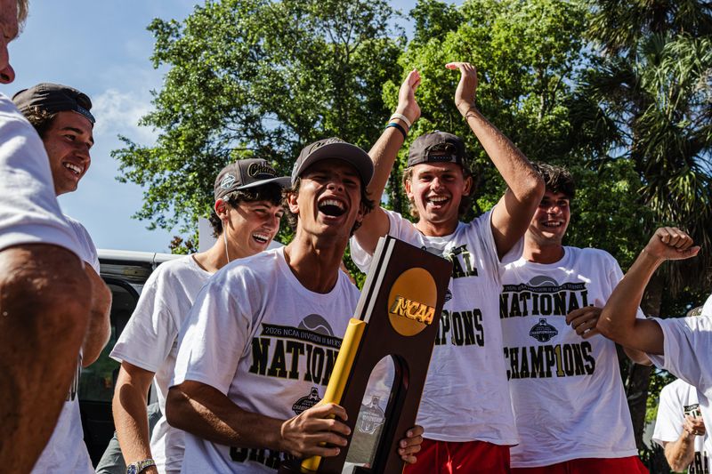Flagler College men's tennis senior and team captain Ilian Borlee holds the NCAA Division II National Championship trophy as he and his teammates arrive in St. Augustine on May 26 after winning the title in Surprise, Ariz., two days before.