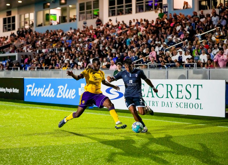 FC Naples defender Julian Cisneros (3) takes the ball near the corner as Orlando City SC midfielder Tyrese Spicer (14) guards him during the second half of the Lamar Hunt U.S. Open Cup Round of 32 game at Paradise Coast Sports Complex in Naples on April 15.