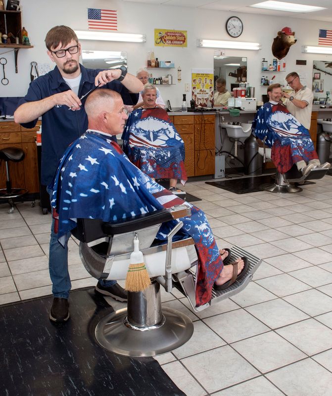 Connor Clayton, the new manager of Jones Barber Shop on North Palafox Street, cuts John Grayson’s hair on May 28, 2026. Clayton got his first haircut from shop owner Charles Jones in 1995. His mother, Joan Clayton, purchased the business in May.