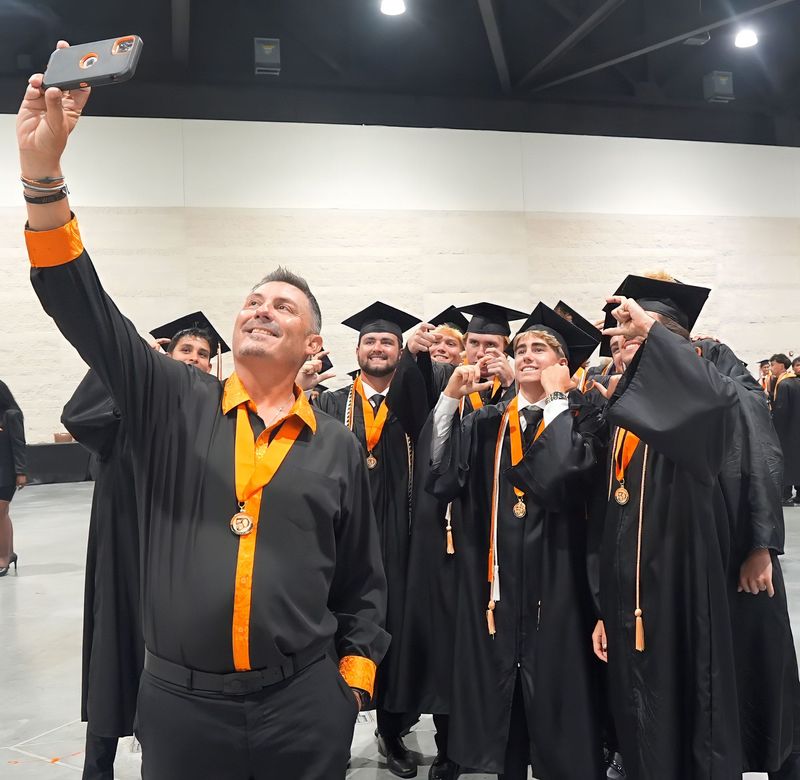 Joey Miller takes a selfie with members of the boys' baseball team Spruce Creek High School's Class of 2026 at the Port Orange school's 50th commencement, May 28, 2026, at the Ocean Center in Daytona Beach.