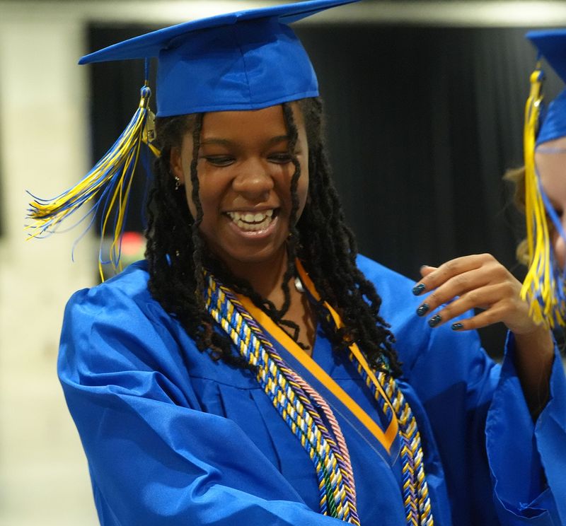 A Mainland High School Class of 2026 student smiles before commencement exercises begin, May 29, 2026, at the Ocean Center in Daytona Beach.