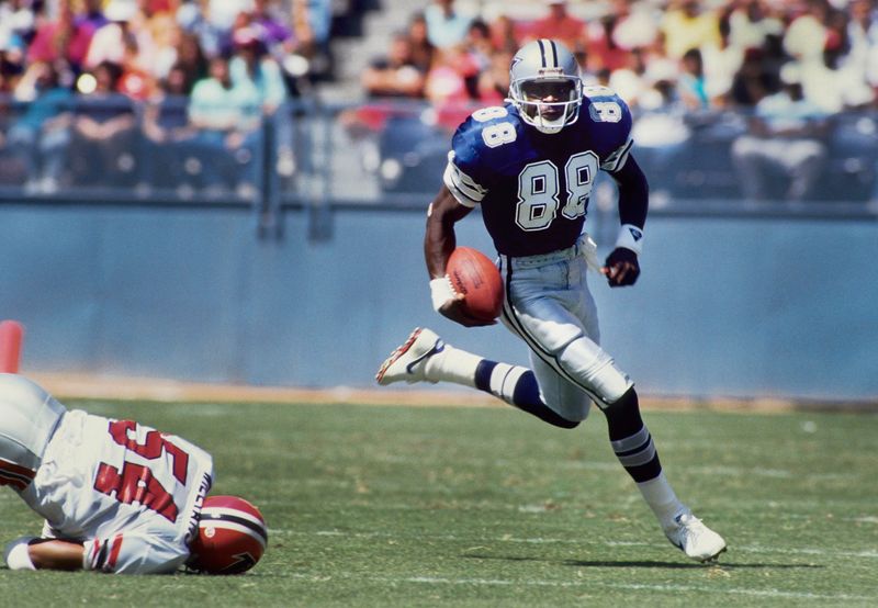 Sep 17, 1989; Atlanta, GA, USA; FILE PHOTO; Dallas Cowboys receiver Michael Irvin (88) carries the ball against the Atlanta Falcons at Fulton County Stadium. Mandatory Credit: Manny Rubio-USA TODAY Sports