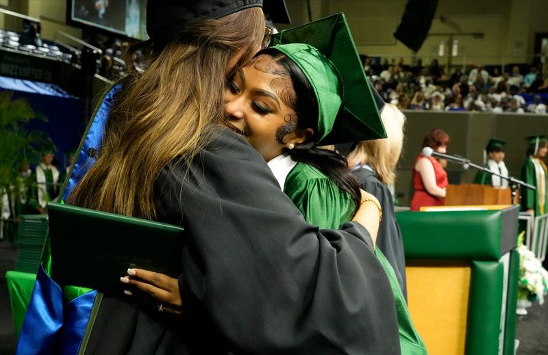 Graduating senior Arionna Canales hugs one of her teachers after accepting her diploma. Approximately 421 seniors graduated from Fort Myers High School, Saturday, May 30, 2026. The ceremony, held at Alico Arena, was an emotional event for faculty, graduates, and family members.