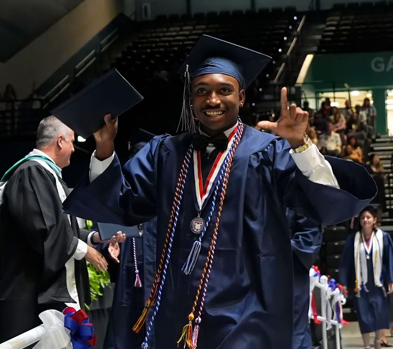 A Taylor Middle-High School Class of 2026 grad celebrates during commencement exercises, May 30, 2026, at the Ocean Center in Daytona Beach.