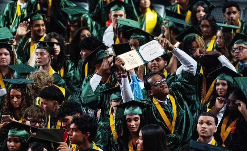 Members of the Island Coast High School graduating class of 2026 including, Brandon Laurent celebrate during graduation at Suncoast Credit Union Arena on the Florida SouthWestern State College on Sunday, May 31, 2026.