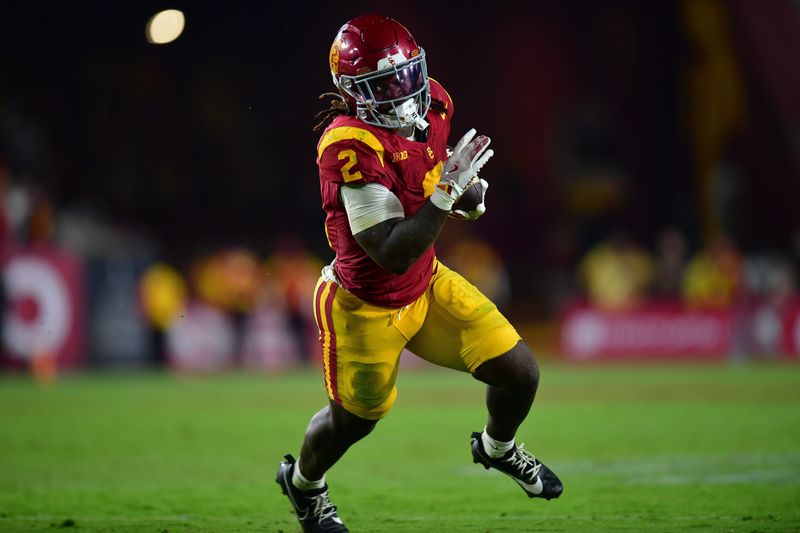 Sep 20, 2025; Los Angeles, California, USA; Southern California Trojans running back Waymond Jordan (2) runs the ball against the Michigan State Spartans during the second half at the Los Angeles Memorial Coliseum. Mandatory Credit: Gary A. Vasquez-Imagn Images