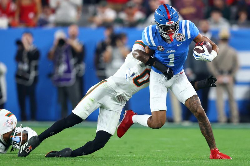 Jan 8, 2026; Glendale, AZ, USA;Mississippi Rebels wide receiver De'zhaun Stribling (1) makes a catch against Miami Hurricanes defensive back Keionte Scott (0) in the second half during the 2026 Fiesta Bowl and semifinal game of the College Football Playoff at State Farm Stadium. Mandatory Credit: Mark J. Rebilas-Imagn Images
